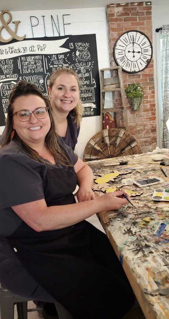 Two members of the Georgia Knotek DDS dental team spending time at an art gallery doing an activity in Greenfield, IN
